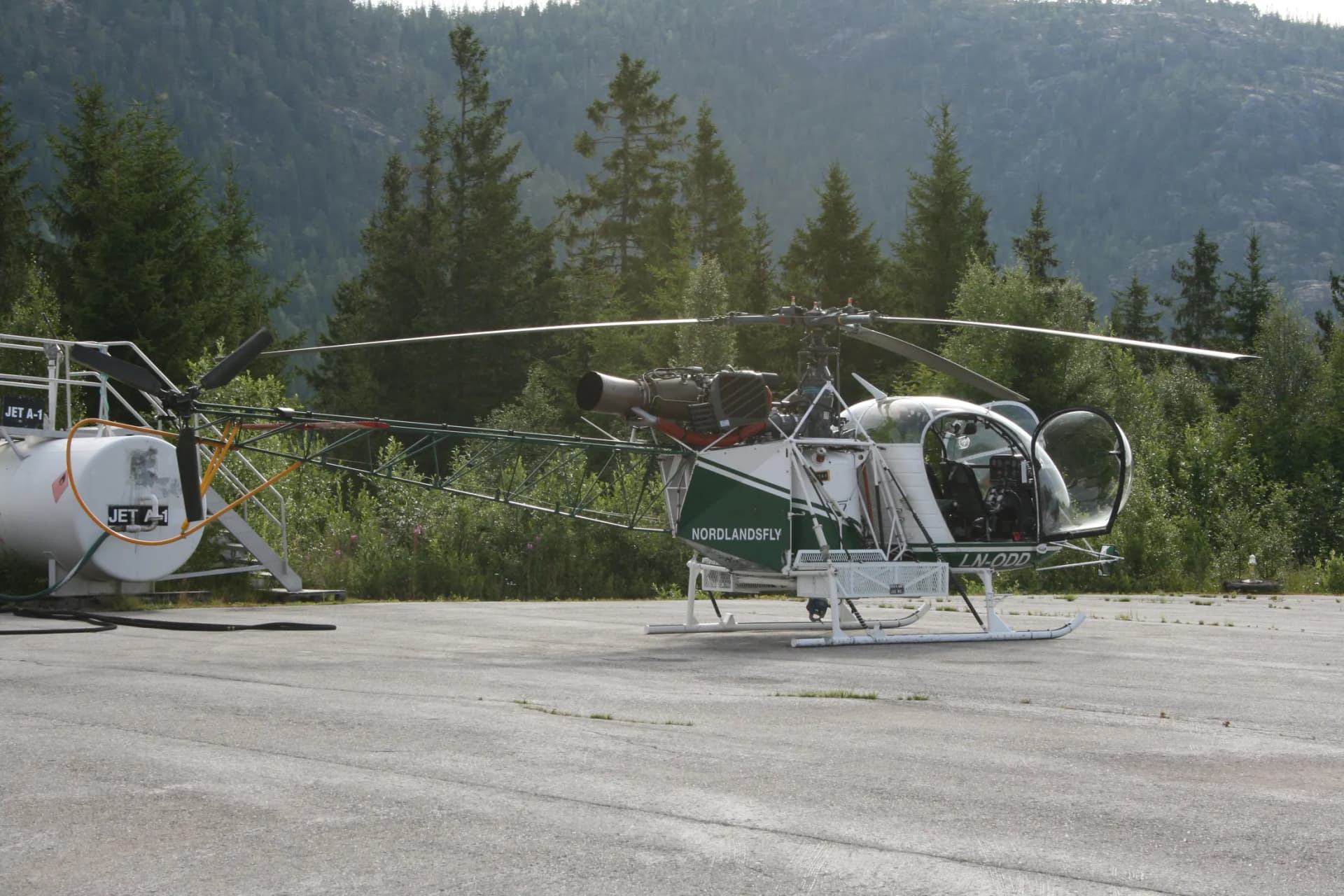 An Aérospatiale SA315B Lama parked at an airport