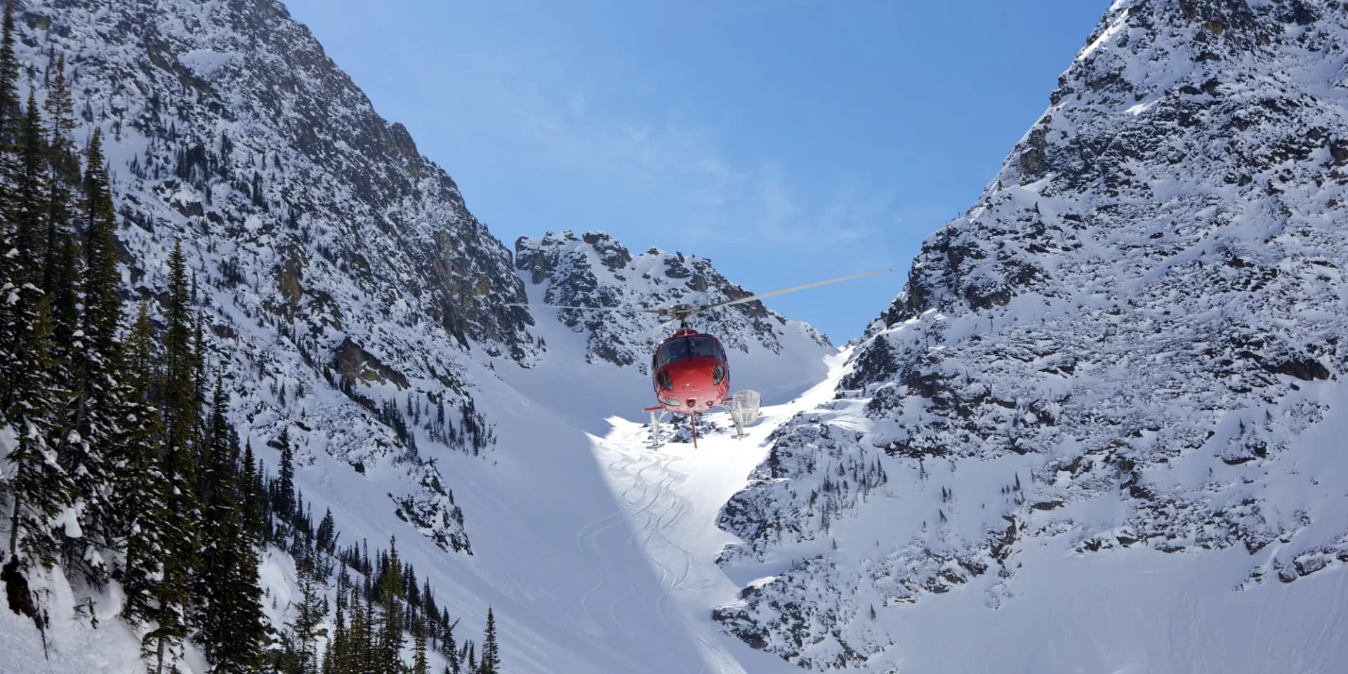 Helicopter flying over snow mountains